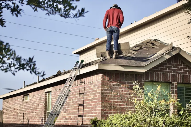 Professional roofer working on a residential roof in La Costa Oaks